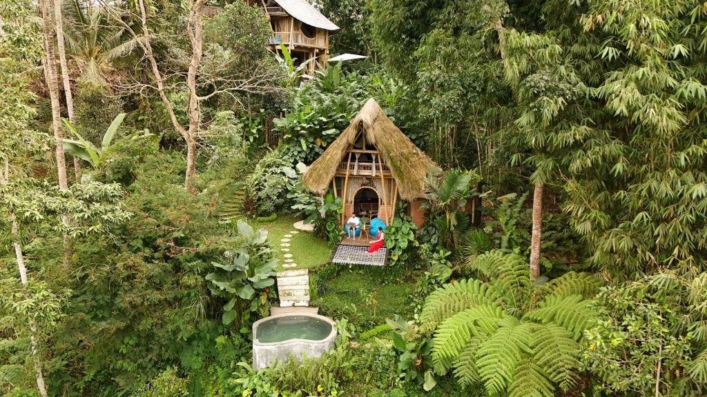 Aerial view of a bamboo hut nestled amidst lush greenery in Bali, Indonesia.