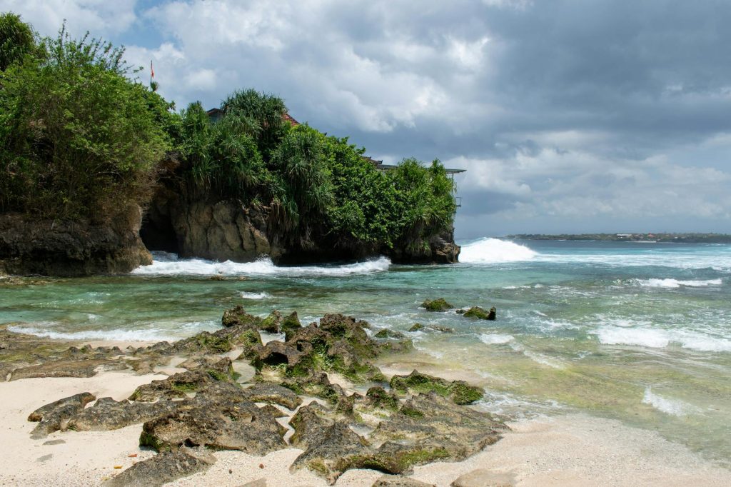 Explore the serene beauty of Padang Padang Beach in Bali featuring clear waters and lush greenery.